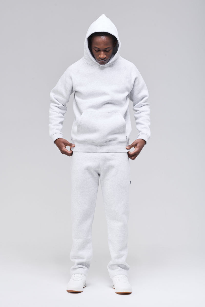 Model wearing a classic hoodie. Front view, arms at sides, looking down