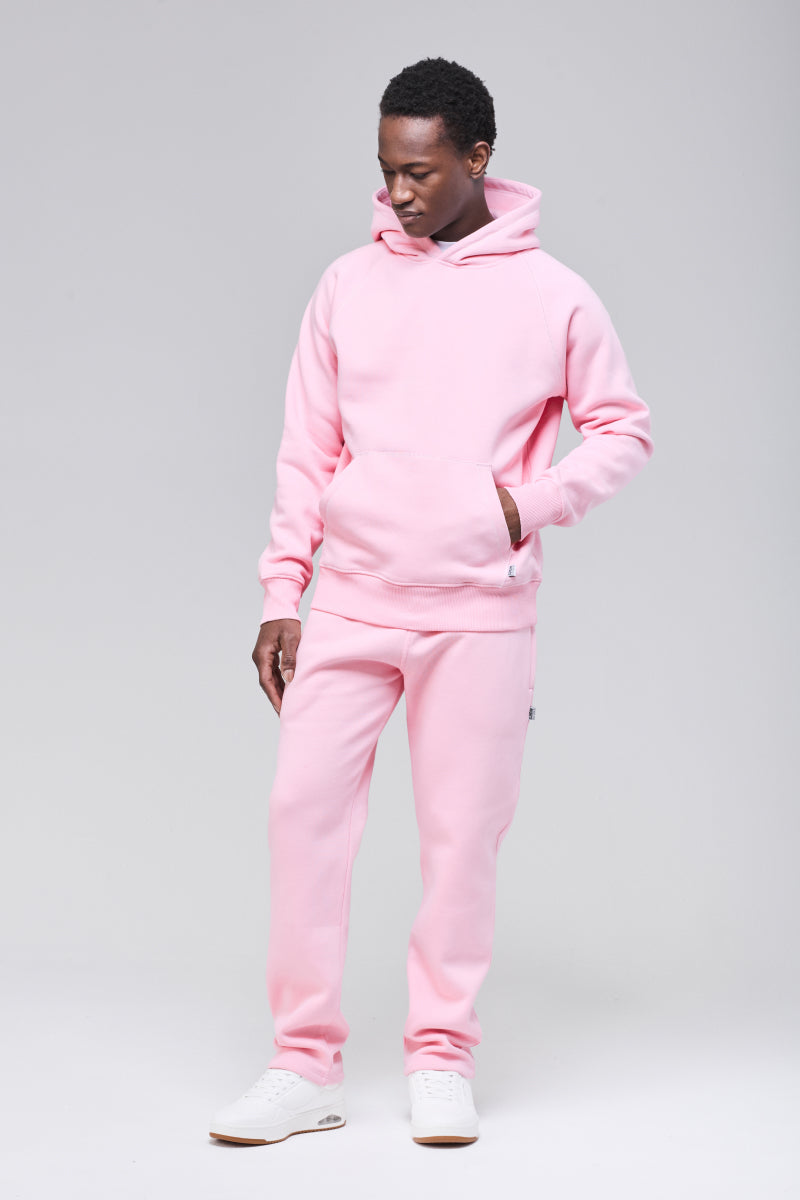 Male model wearing pink classic hoodie, hand in front pocket