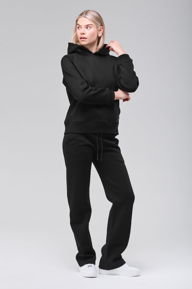 Slightly angled front view, hand holding hood, model looking to the side